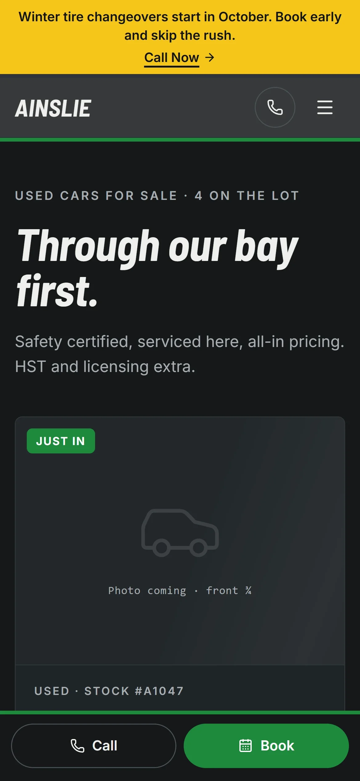 The lot, Ainslie Auto Repair & Sales, on a phone